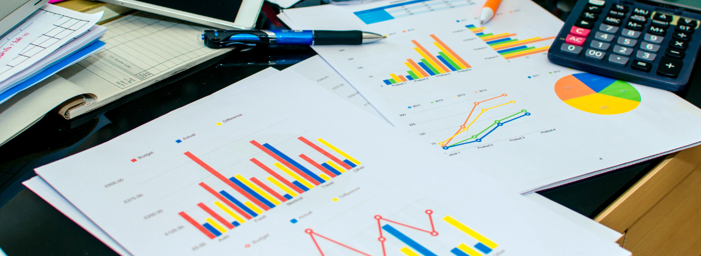 graph reports on desk with calculator