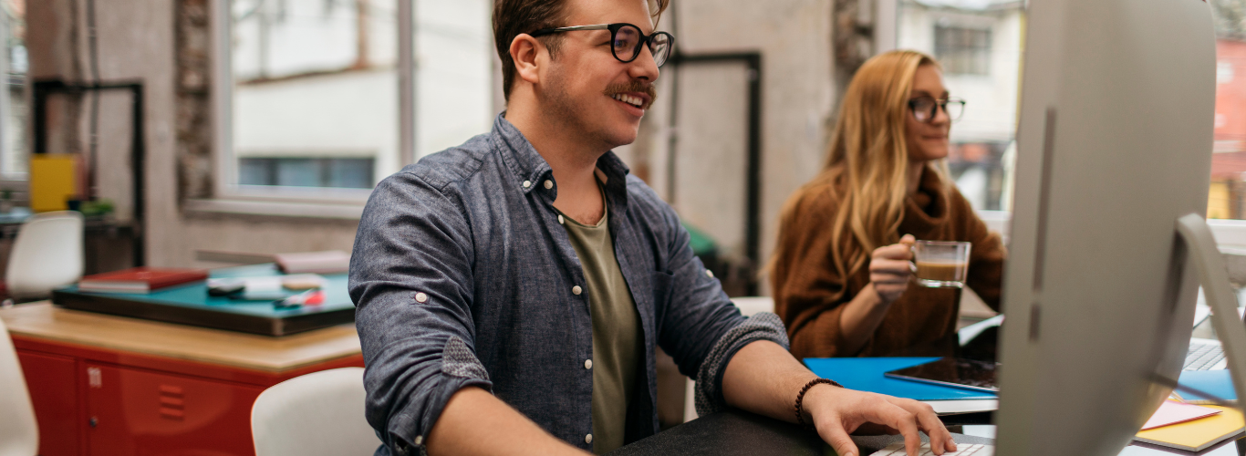 Why QuickBooks Online is a Good Bookkeeping Software for Your Business a man sitting at a desk with a woman in a blue shirt