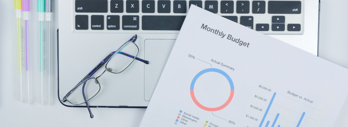 How to Create and Manage a Budget Using Your Bookkeeping Data keyboard with glasses and budget sheet