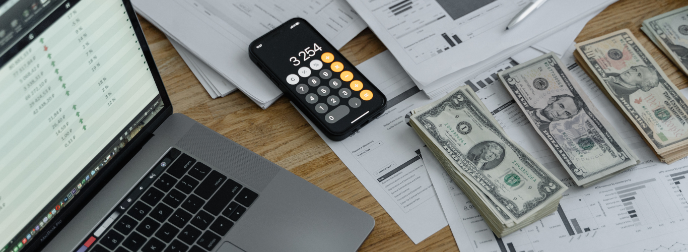 How a Bookkeeper Can Help with Payroll Services a laptop computer and a cell phone on a desk