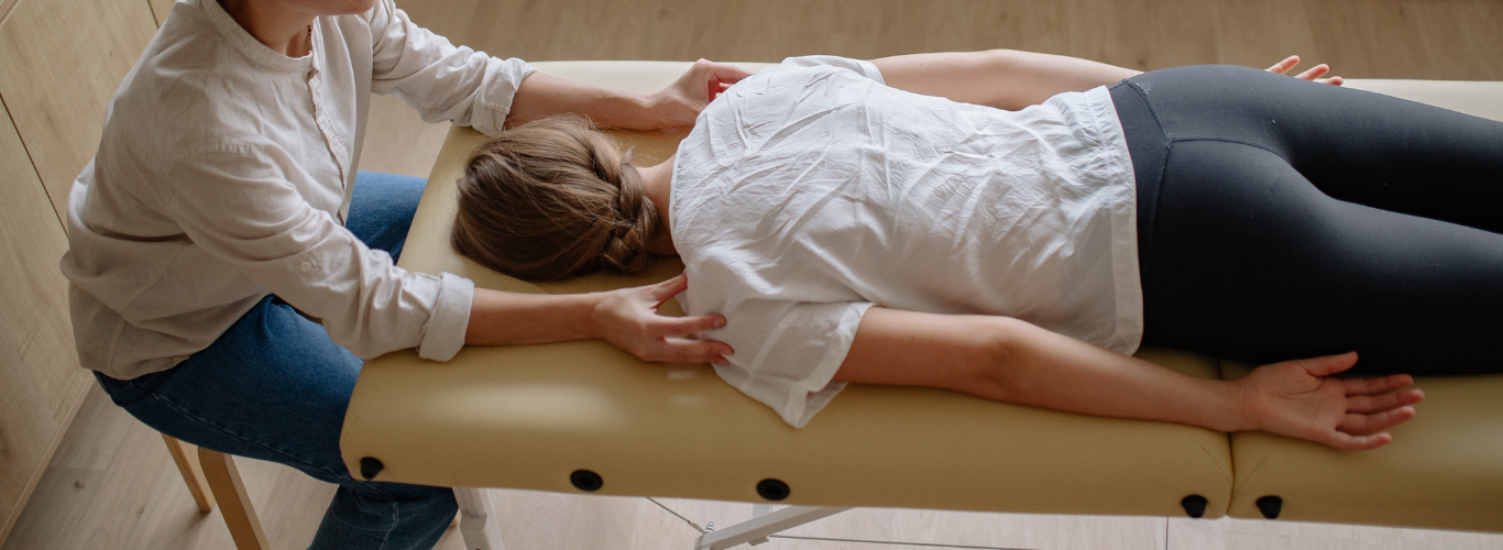 Common Challenges Chiropractors Encounter Without a Bookkeeper Copy a woman at the chiropractor on a table