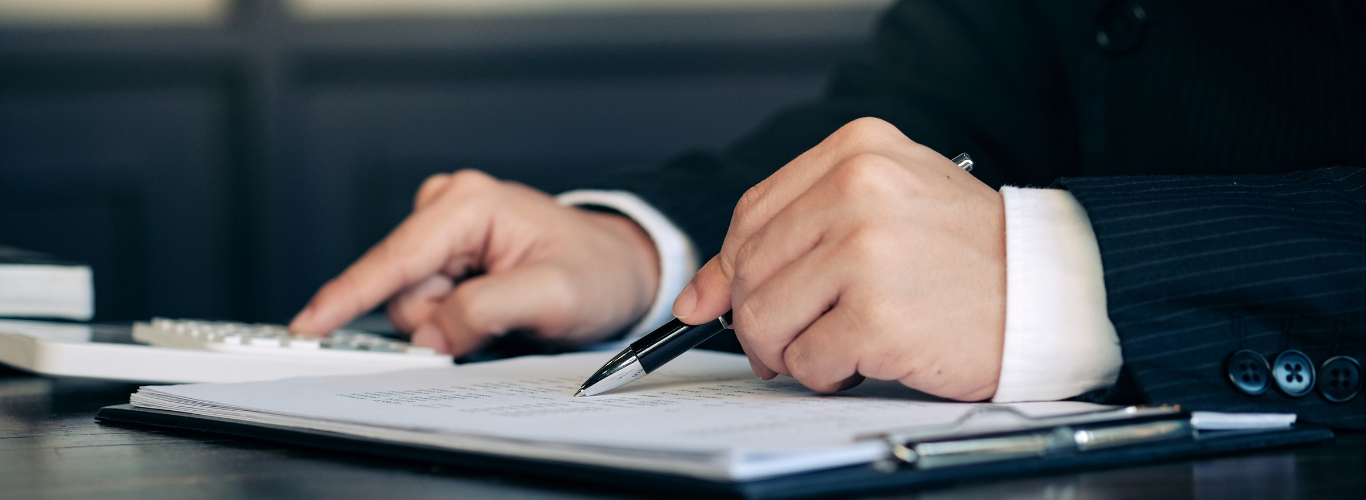 Why Regular Bank Reconciliations Are Important for Your Business Copy a person in a suit and tie is writing on a notebook